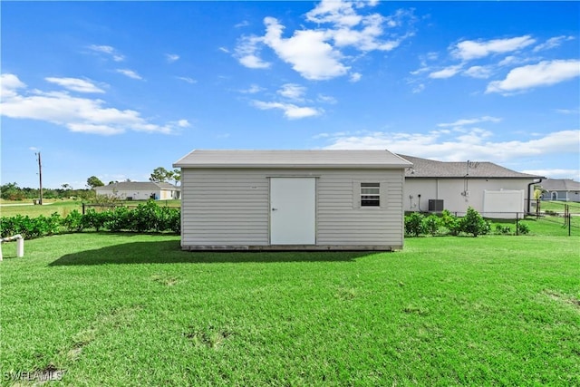 view of outbuilding with a lawn and central AC