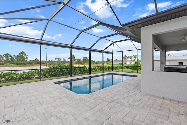 view of pool with a patio area, a lanai, ceiling fan, and area for grilling