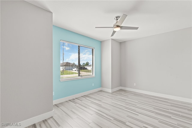 spare room featuring ceiling fan and light hardwood / wood-style flooring