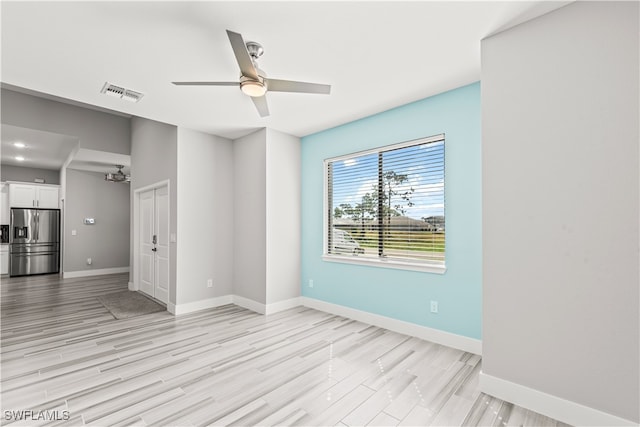 unfurnished room featuring ceiling fan and light wood-type flooring