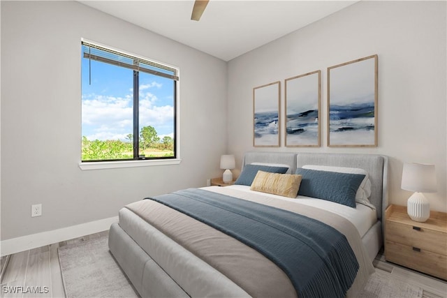 bedroom with ceiling fan and light wood-type flooring