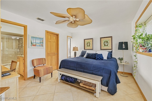 tiled bedroom featuring multiple windows, ensuite bath, and ceiling fan