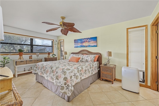 tiled bedroom featuring ceiling fan