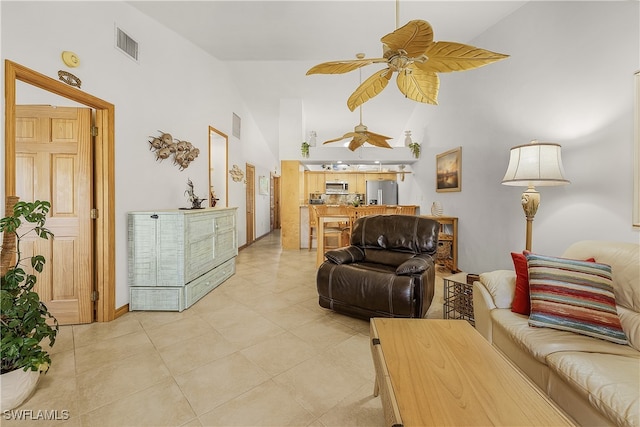 living room with ceiling fan, high vaulted ceiling, and light tile patterned floors