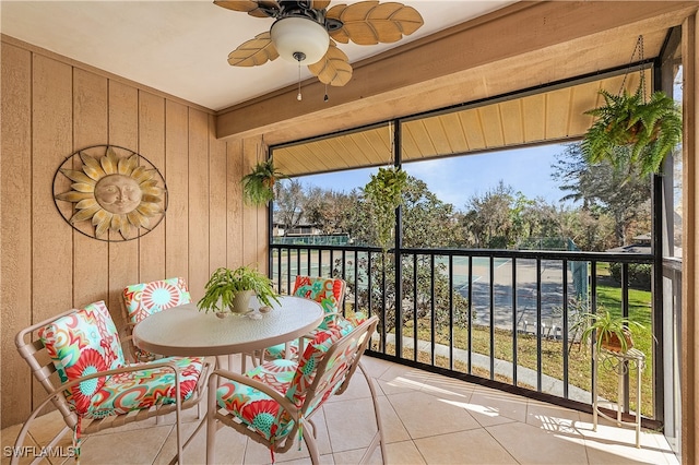 sunroom / solarium featuring ceiling fan