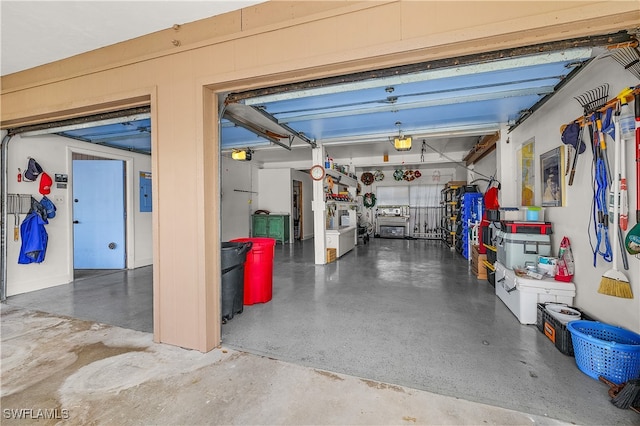 garage featuring a garage door opener and electric panel