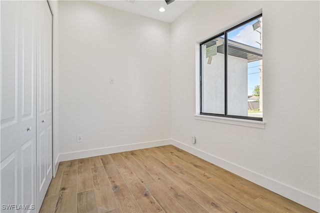 empty room with light hardwood / wood-style flooring