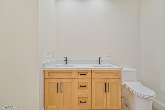 bathroom with toilet and vanity