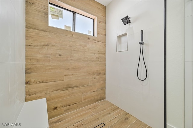 bathroom featuring hardwood / wood-style flooring and a shower