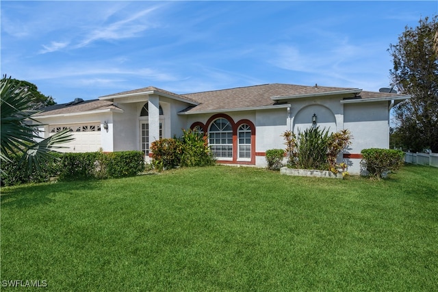 single story home featuring a front yard and a garage