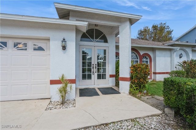 property entrance with french doors and a garage