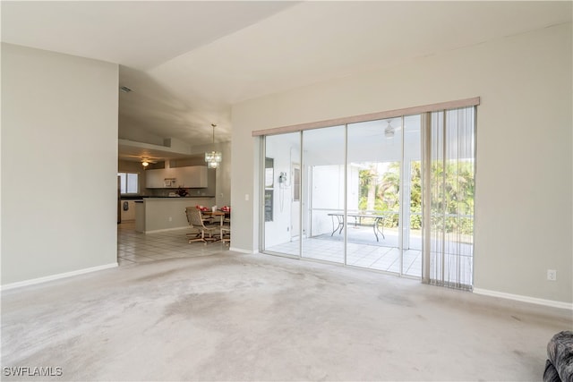 unfurnished living room with light carpet, lofted ceiling, and ceiling fan