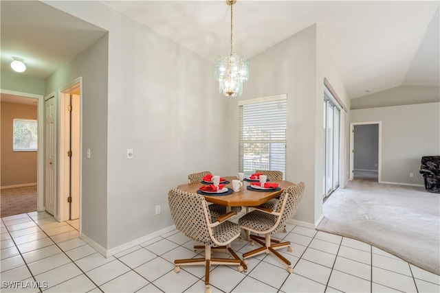 carpeted dining area with vaulted ceiling and an inviting chandelier