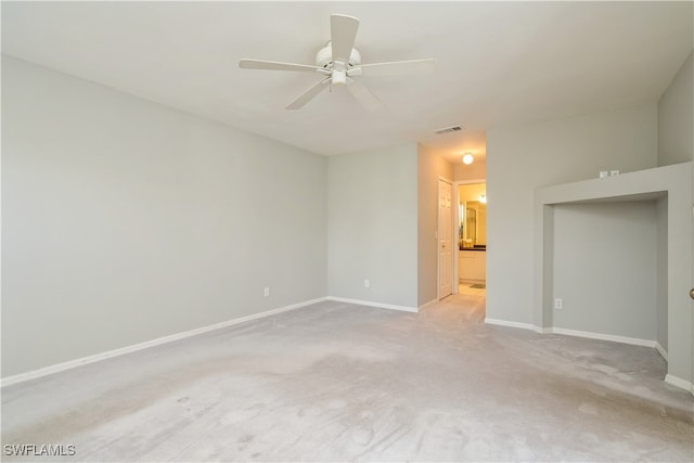 spare room featuring light colored carpet and ceiling fan