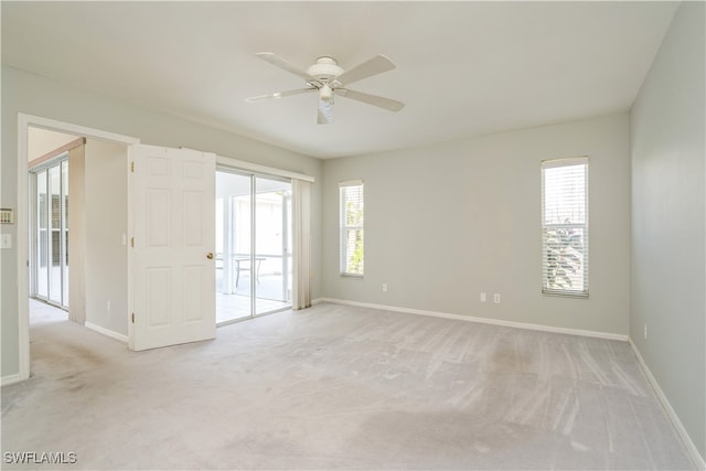 carpeted empty room featuring ceiling fan and a healthy amount of sunlight