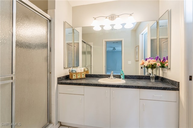 bathroom with vanity and a shower with door