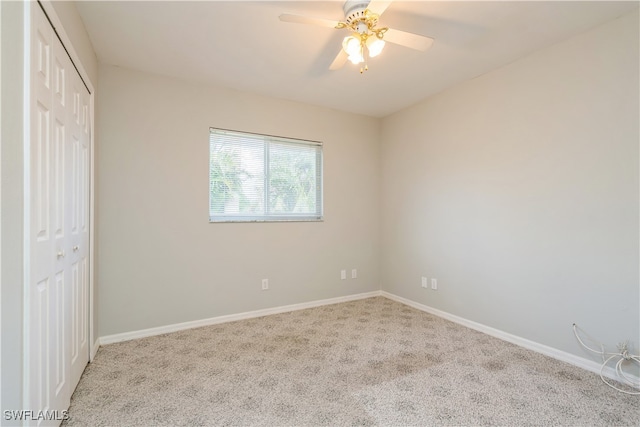 unfurnished bedroom with light carpet, a closet, and ceiling fan