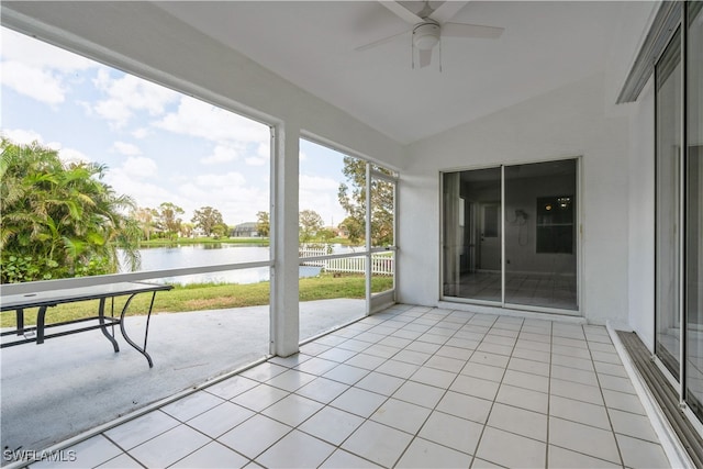 unfurnished sunroom featuring vaulted ceiling, a water view, and ceiling fan