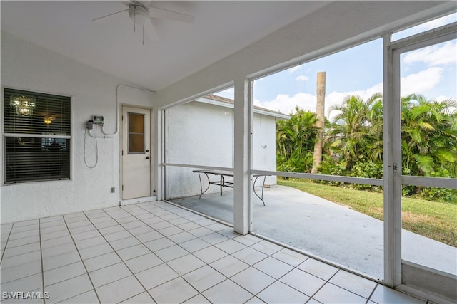 unfurnished sunroom featuring vaulted ceiling and ceiling fan