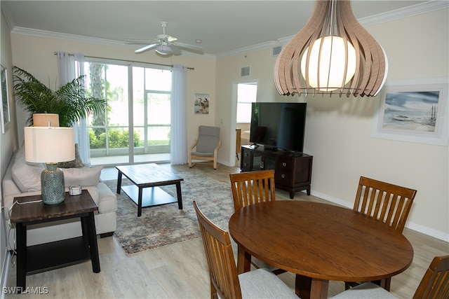 living room featuring ornamental molding, light hardwood / wood-style flooring, and ceiling fan