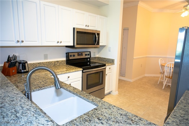 kitchen featuring crown molding, white cabinets, stainless steel appliances, and sink