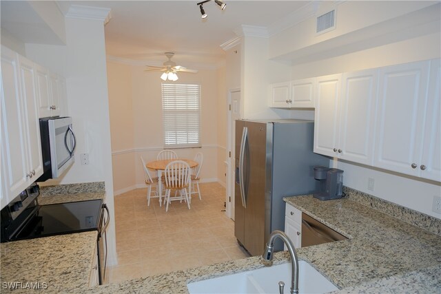 kitchen with black range with electric stovetop, sink, white cabinetry, light stone counters, and ornamental molding