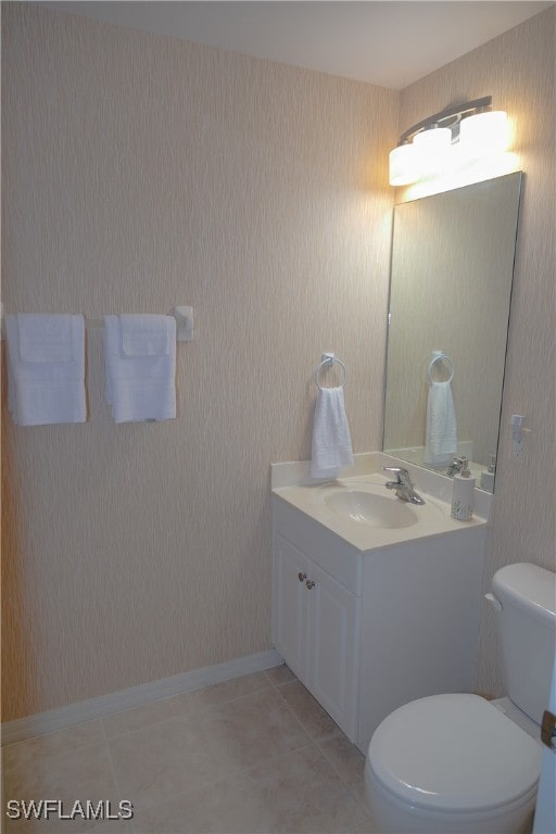 bathroom featuring vanity, toilet, and tile patterned flooring