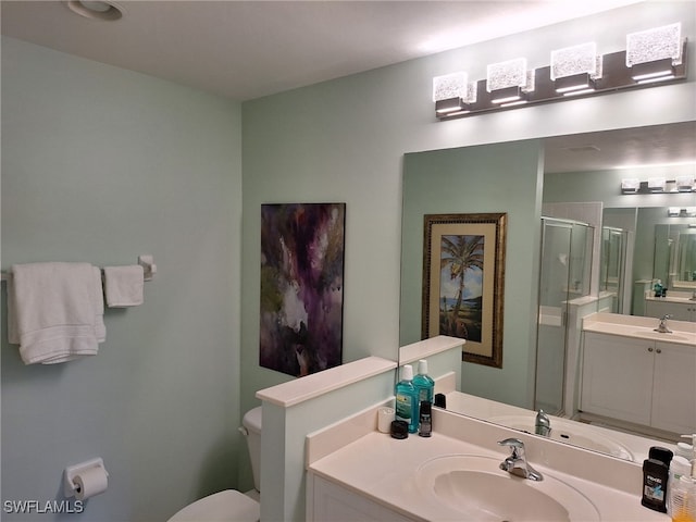 bathroom with vanity, toilet, and an enclosed shower