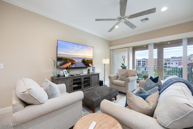 living room with hardwood / wood-style floors, ceiling fan, and crown molding