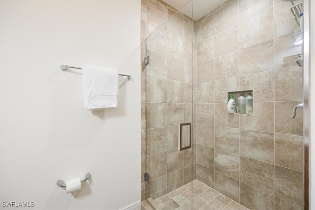 bathroom with a shower with shower door