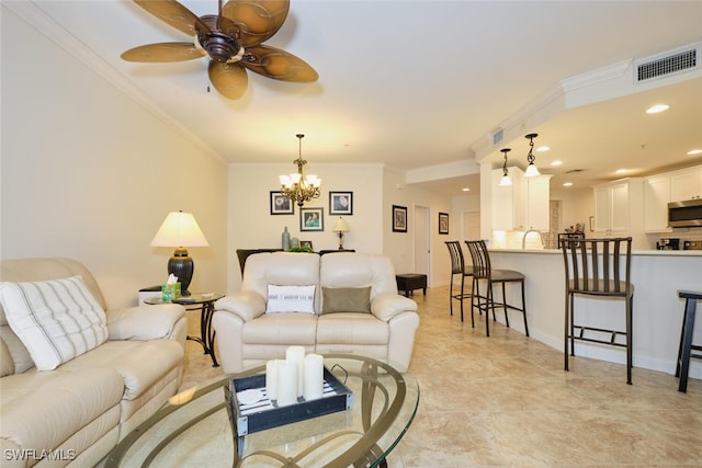 tiled living room featuring ornamental molding and ceiling fan with notable chandelier