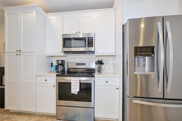 kitchen with appliances with stainless steel finishes and white cabinets