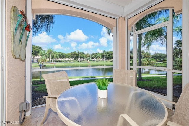 sunroom / solarium with a water view