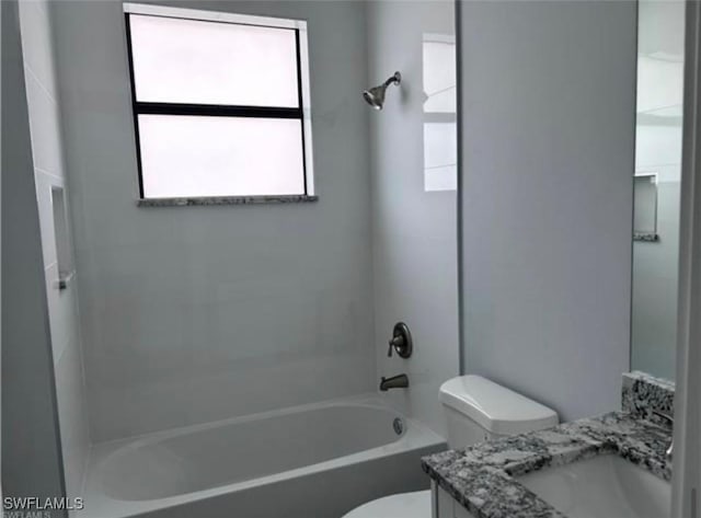 full bathroom featuring vanity, bathtub / shower combination, and toilet