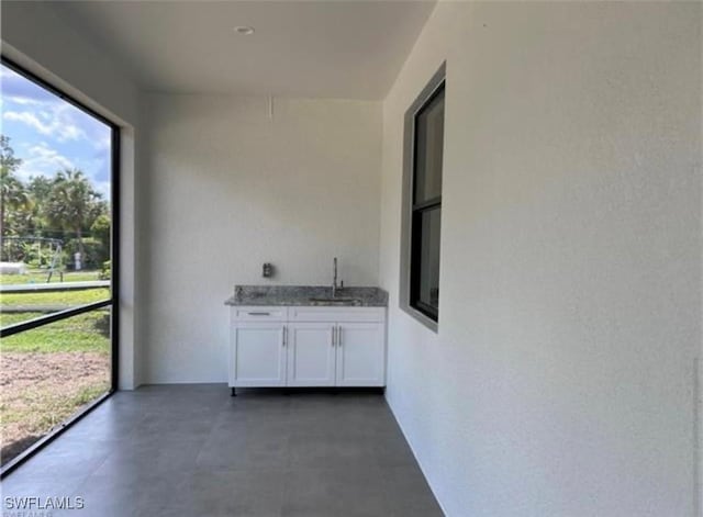 unfurnished sunroom featuring sink