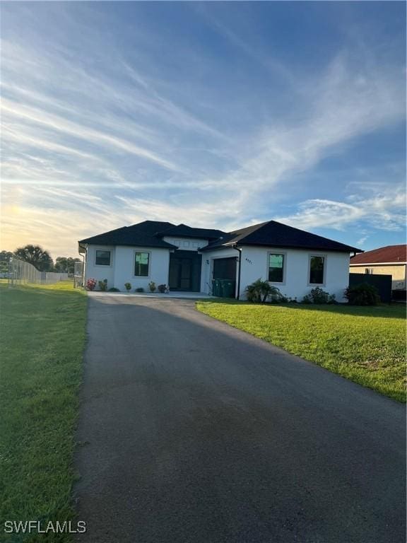 ranch-style house with a garage and a front yard