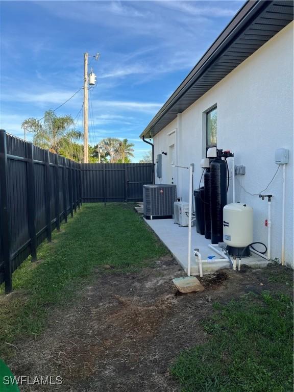 view of yard with cooling unit and a patio area