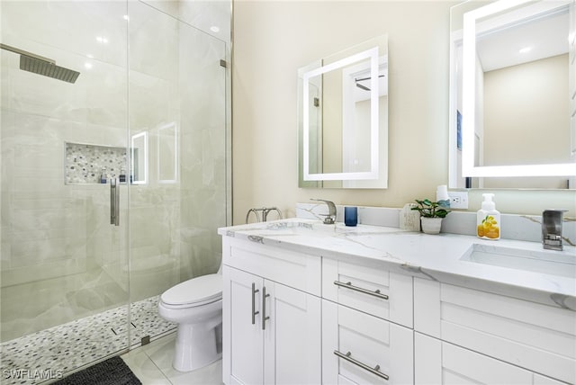 bathroom with toilet, a shower with shower door, vanity, and tile patterned floors