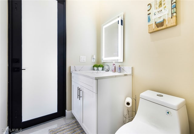 bathroom with toilet and vanity