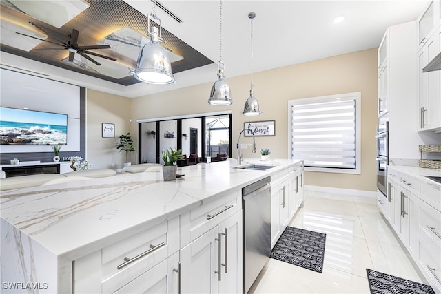 kitchen with sink, pendant lighting, white cabinets, and stainless steel appliances