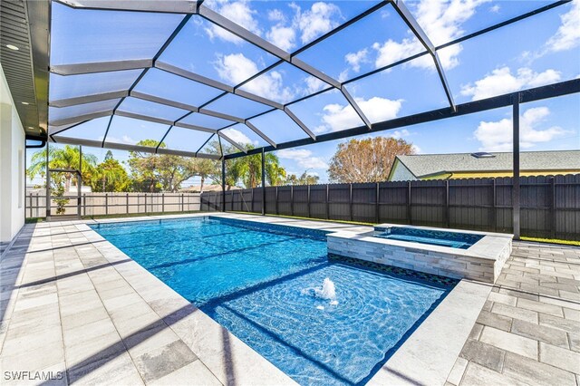 view of pool with an in ground hot tub, a patio area, and a lanai