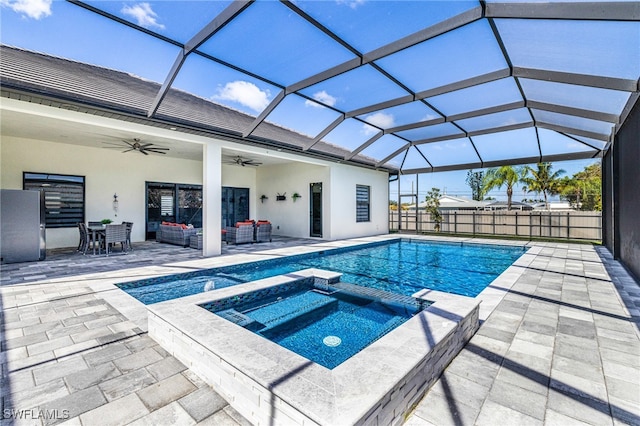 view of pool featuring a patio area, ceiling fan, an in ground hot tub, and glass enclosure