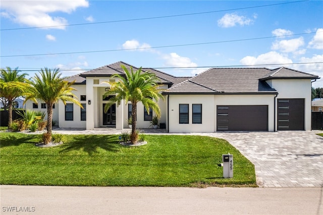 view of front of house with a front lawn and a garage