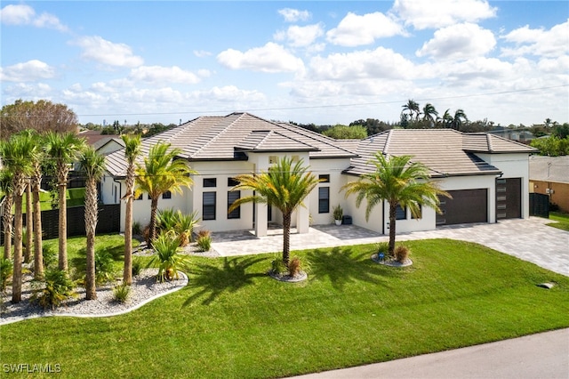 view of front facade with a front yard and a garage