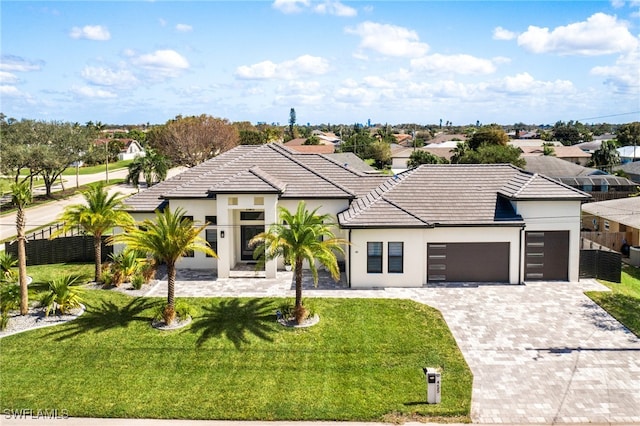 view of front facade with a front yard and a garage