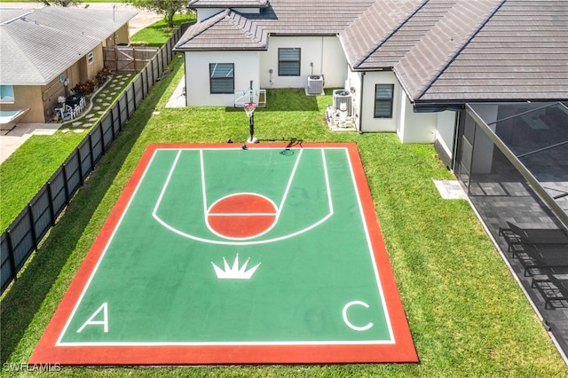 view of sport court with a lawn