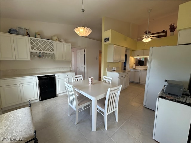 dining room with lofted ceiling, beverage cooler, light tile patterned floors, and ceiling fan