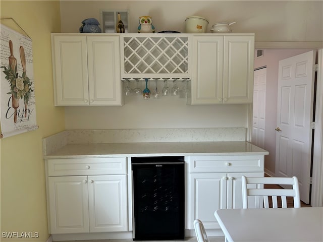 kitchen with white cabinetry and beverage cooler