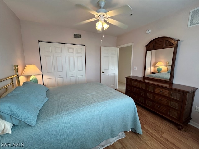 bedroom featuring a closet, wood-type flooring, and ceiling fan