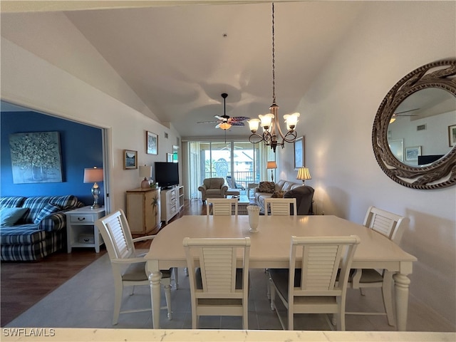 dining area featuring lofted ceiling, dark wood-type flooring, and ceiling fan with notable chandelier